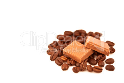 Two pieces of chocolate on coffee seeds