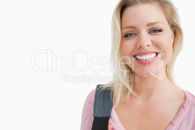 Happy young woman holding a shoulder bag