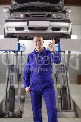 Mechanic standing doing a gesture with his fingers