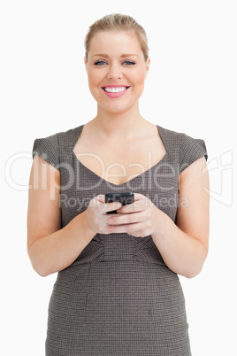 Woman smiling texting with her smartphone