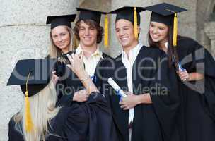 Graduate taking a picture of her friend