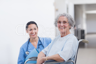 Patient in a wheelchair next to a nurse