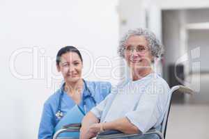 Patient in a wheelchair next to a nurse
