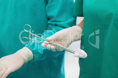 Close up of a surgical scissors with a compress