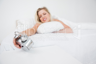 Woman looking at her alarm clock