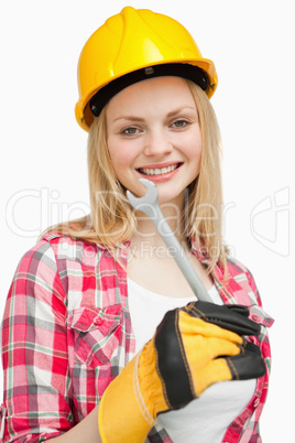 Woman holding a wrench while standing