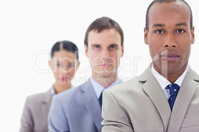 Big close-up of a business team in a single line looking straigh