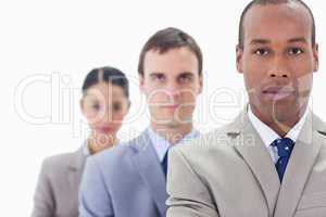 Big close-up of a business team in a single line looking straigh