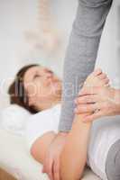 Physiotherapist manipulating the arm of a patient