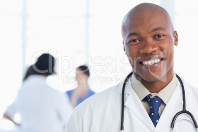 Smiling doctor standing with his stethoscope around his neck