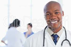 Smiling doctor standing with his stethoscope around his neck
