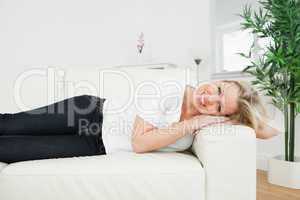 Casual woman lying on a white sofa