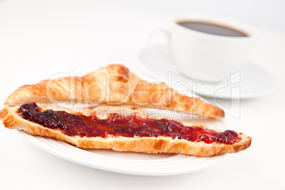 Croissant placed in front of a coffee cup