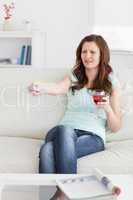 Woman pressing a remote control while sitting