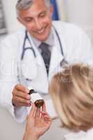 Doctor giving a bottle of drugs to a patient