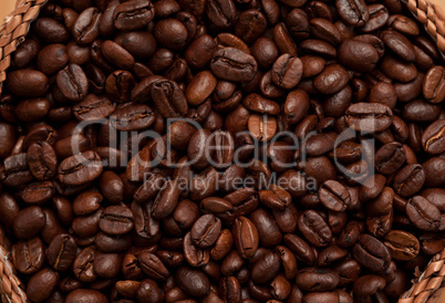 Close up of a basket full of dark coffee beans