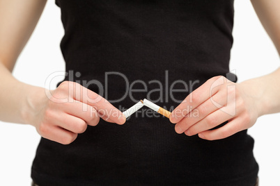 Close up of hands breaking a cigarette