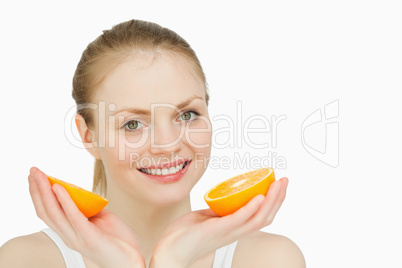 Smiling woman holding oranges