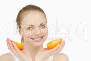 Smiling woman holding oranges