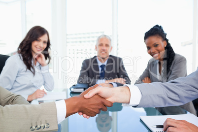 Two executives shaking hands during a meeting