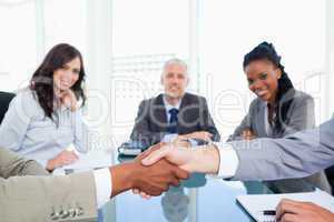 Two executives shaking hands during a meeting