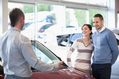 Smiling couple in a car shop