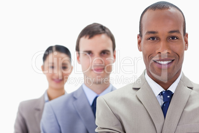 Big close-up of people dressed in suits smiling in a single line