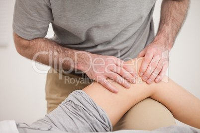 Physiotherapist massaging the knee of a woman