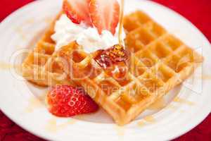 Waffles with whipped cream and strawberries
