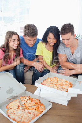 A group of friends about to eat pizza