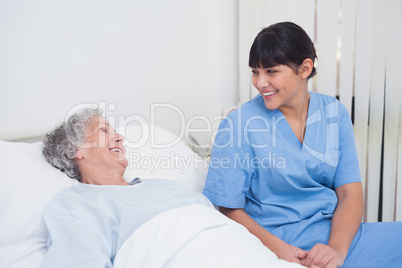 Nurse smiling to an elderly patient