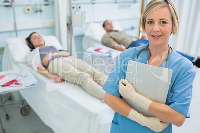 Nurse standing next to transfused patients