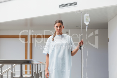 Female patient walking with a drip stand