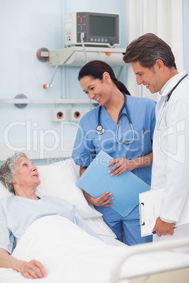 Elderly patient talking to a doctor and a nurse