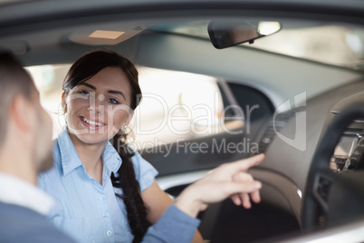 Man pointing a car interior
