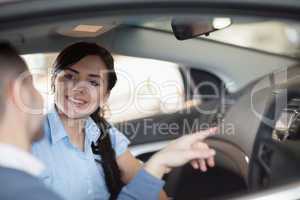 Man pointing a car interior