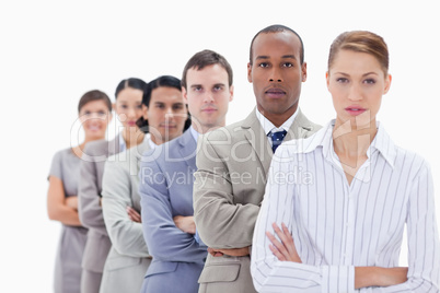 Close-up of colleagues dressed in suits crossing their arms in a