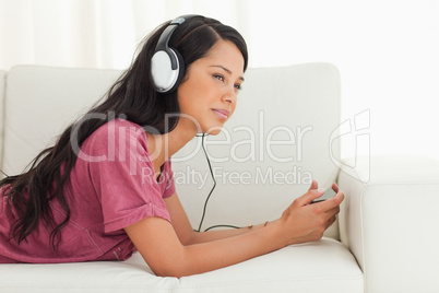 Young Latino listening music with a blank stare
