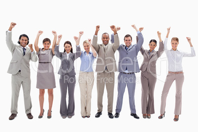 Happy business team raising their arms