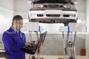 Mechanic holding a laptop