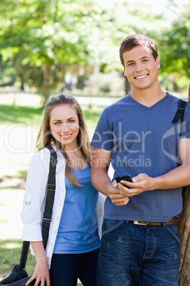Portrait of two students with a smartphone