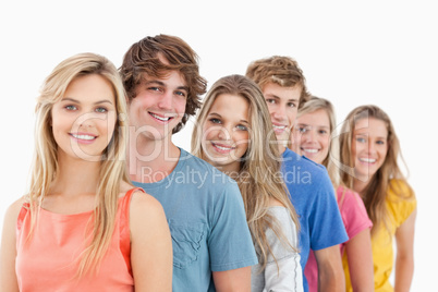 A smiling group standing behind each other