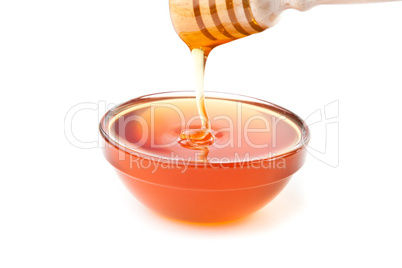 Honey trickle dropping in honey bowl