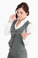 Attractive woman in suit speaking through the phone