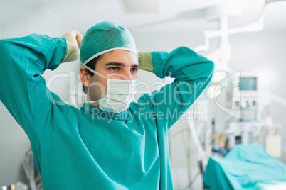 Surgeon attaching his mask