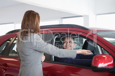 Businesswoman presenting something to a man