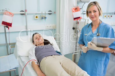Nurse next to a patient while standing