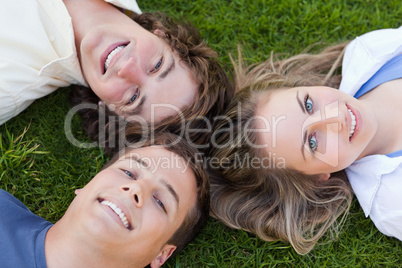 Close-up on three students lying together