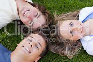 Close-up on three students lying together