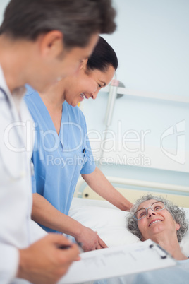 Patient laughing with a nurse and a doctor